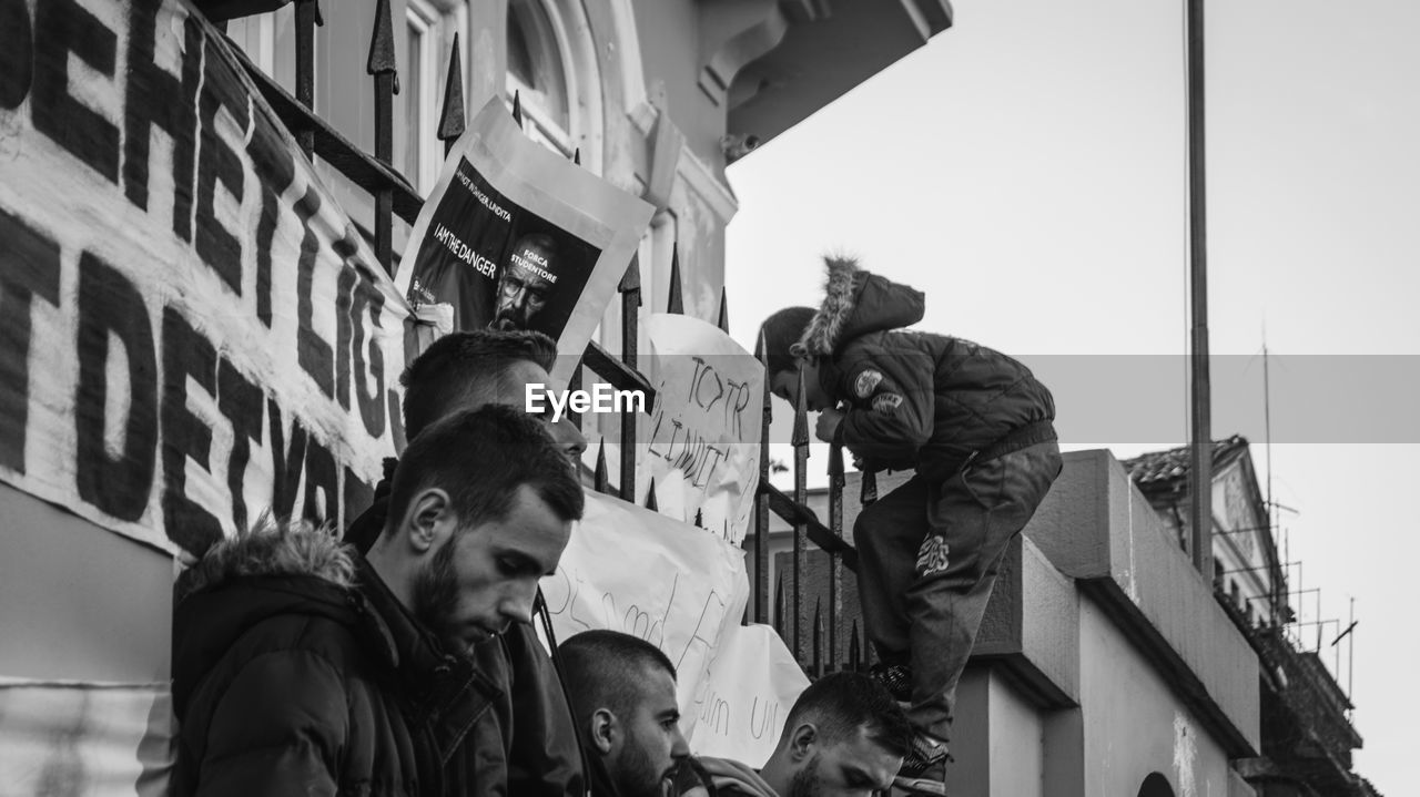 LOW ANGLE VIEW OF PEOPLE IN CITY BUILDINGS