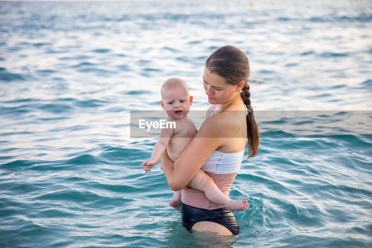 Mother with daughter in sea
