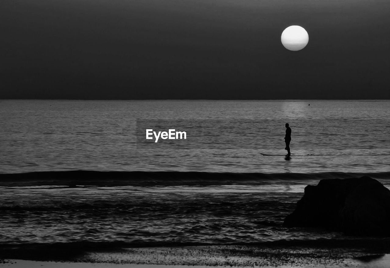 Scenic view of sea against sky at night