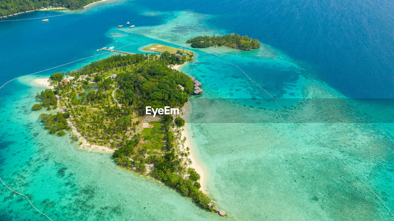 Aerial drone of seascape with beautiful beach and tropical malipano island. philippines, samal.