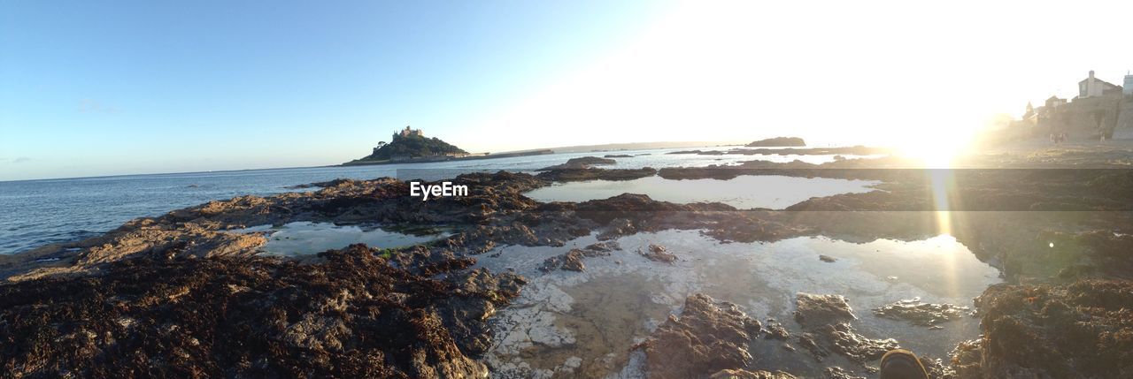 Scenic view of sea against sky during sunny day