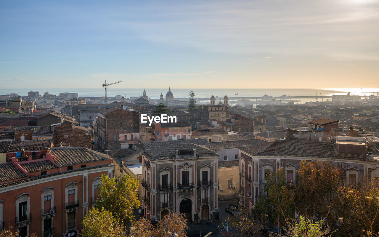 Catania city center, with sant'agata cathedral and medieval town rooftops, sicily, italy, at sunrise