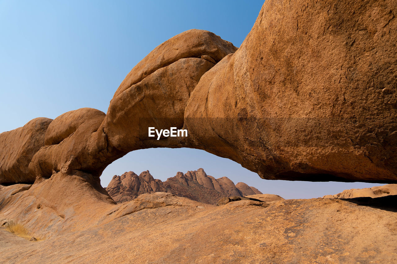 low angle view of rock formations against sky