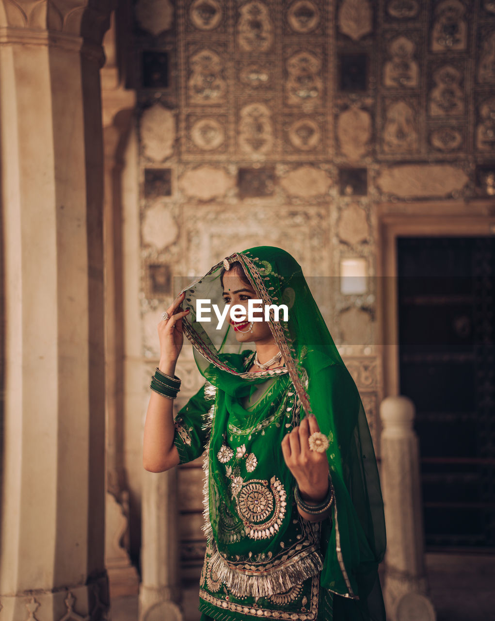 Woman in traditional clothing standing in a palace