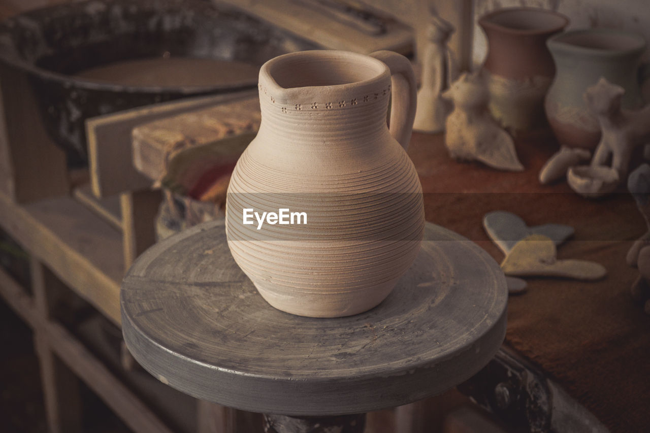 Clay jug on a potter's wheel close-up. copy spase