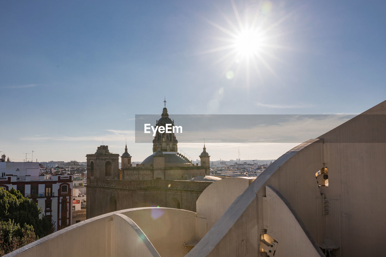 Historic church in city against blue sky