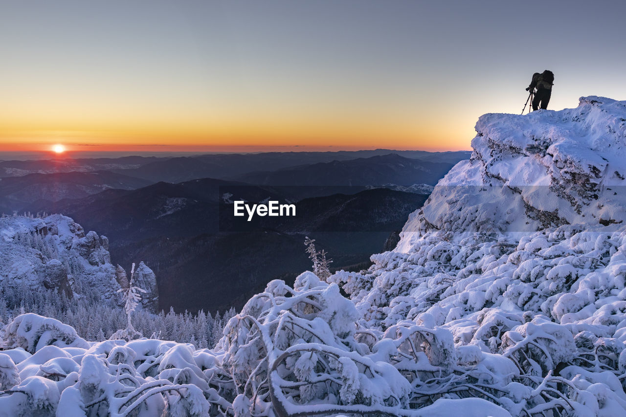 Scenic view of snowcapped mountains against sky during sunset