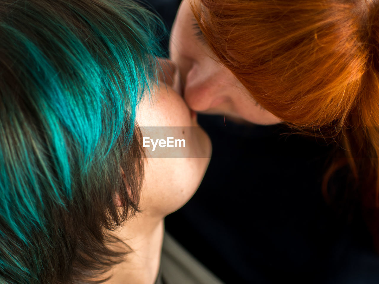 Close-up of lesbian couple kissing at home