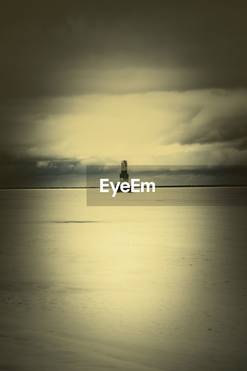 water, sky, sea, reflection, cloud, horizon, beauty in nature, horizon over water, nautical vessel, tranquility, scenics - nature, nature, tranquil scene, morning, transportation, dawn, mode of transportation, waterfront, ocean, light, sunrise, ship, sunlight, darkness, no people, idyllic, silhouette, outdoors, sailing, wave, coast, beach