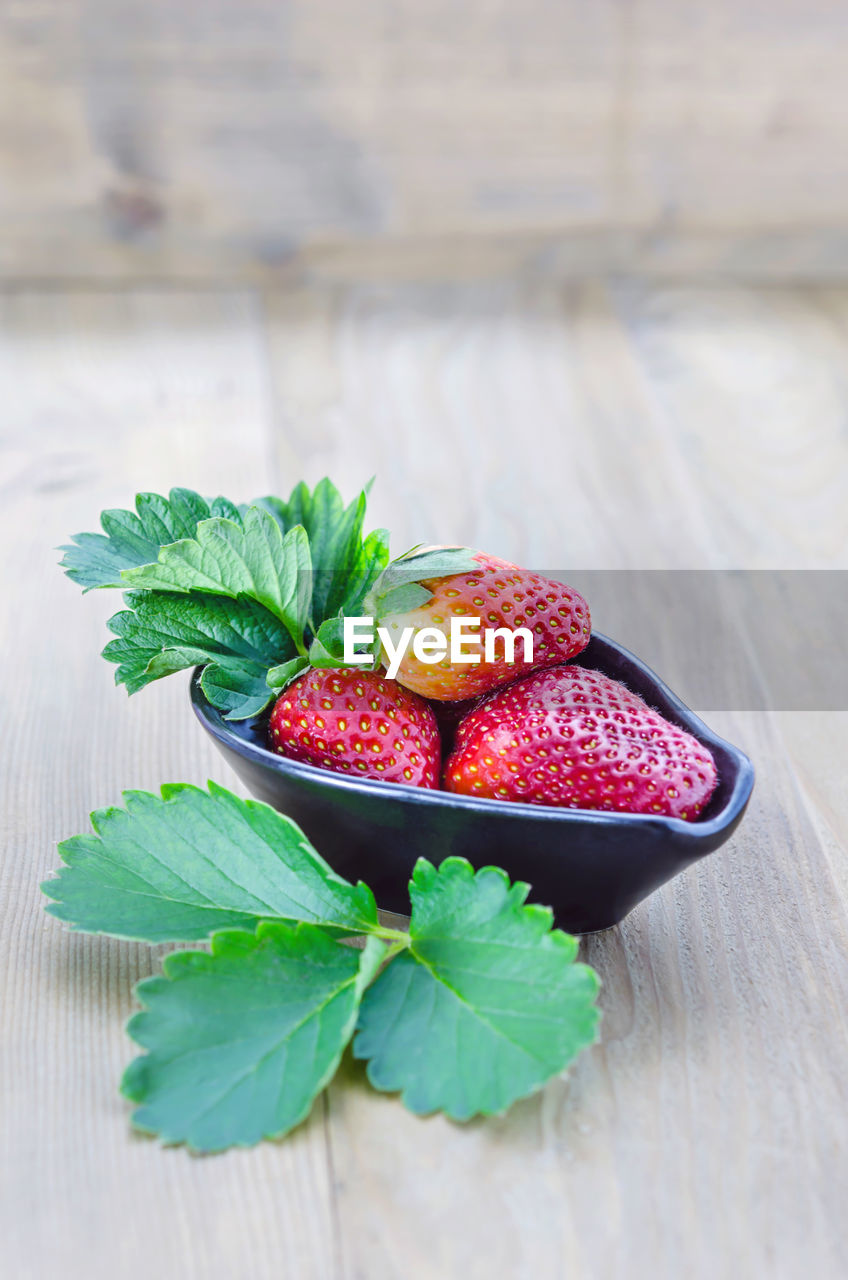 Close-up of strawberries in bowl on table