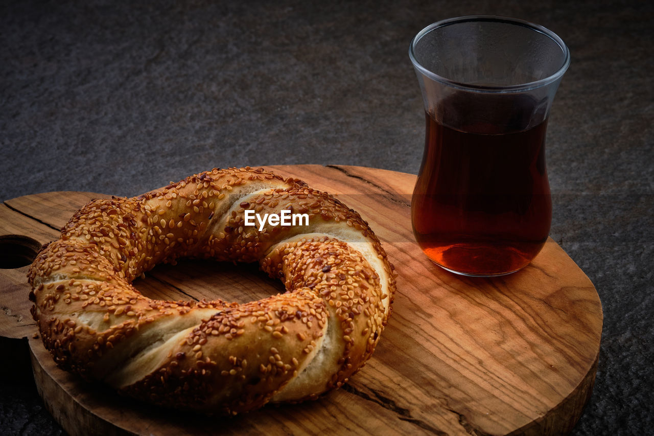 Traditional turkish bagel and  traditional turkish tea served on a dark stone surface