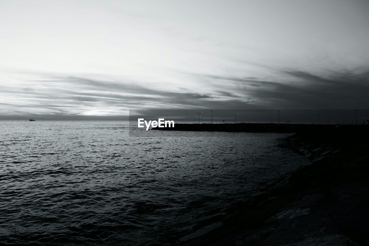 View of seascape against cloudy sky