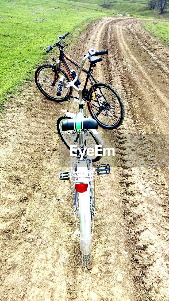 BICYCLE PARKED IN GRASS