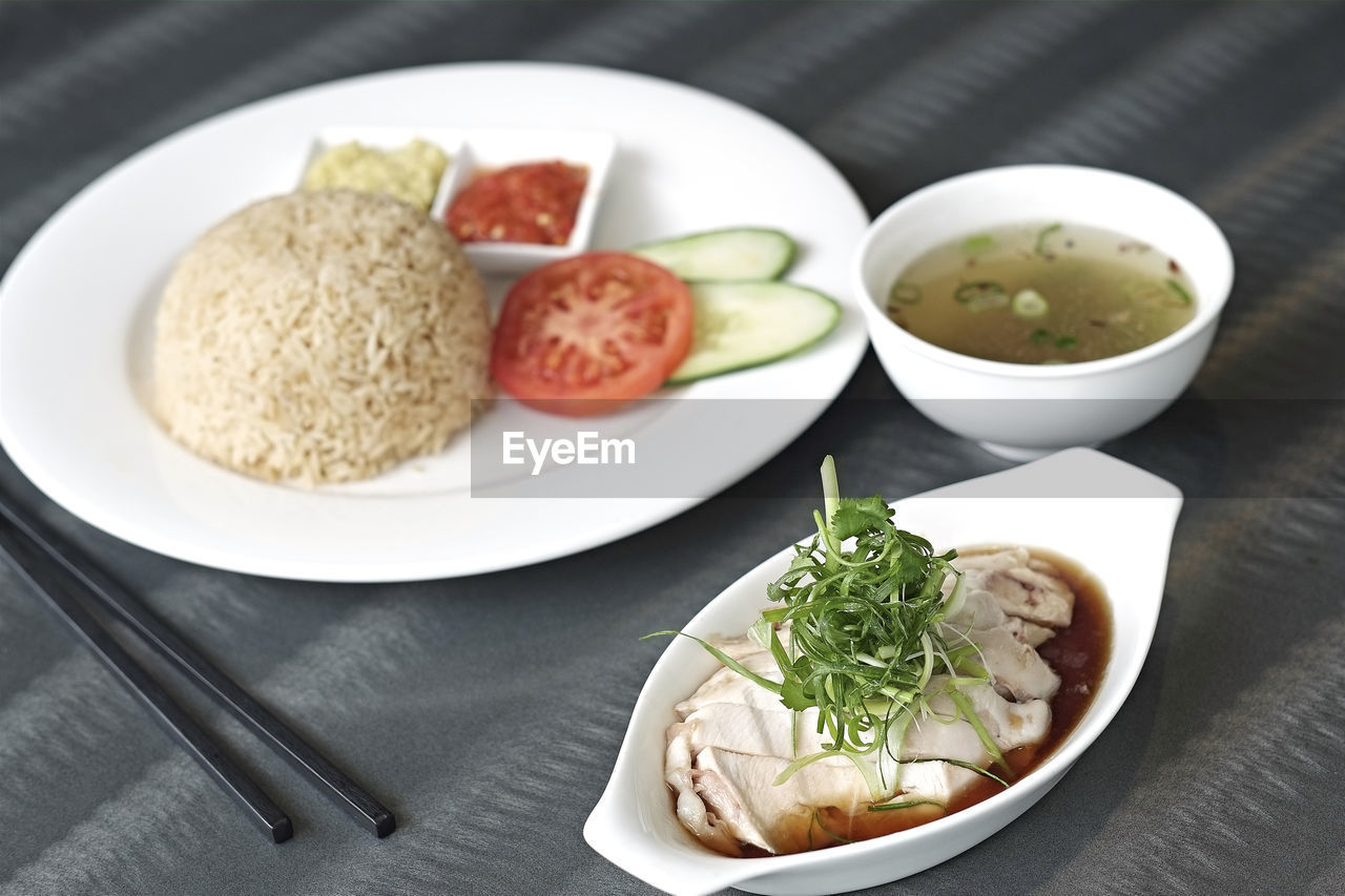 Close-up of hainanese chicken rice served on table