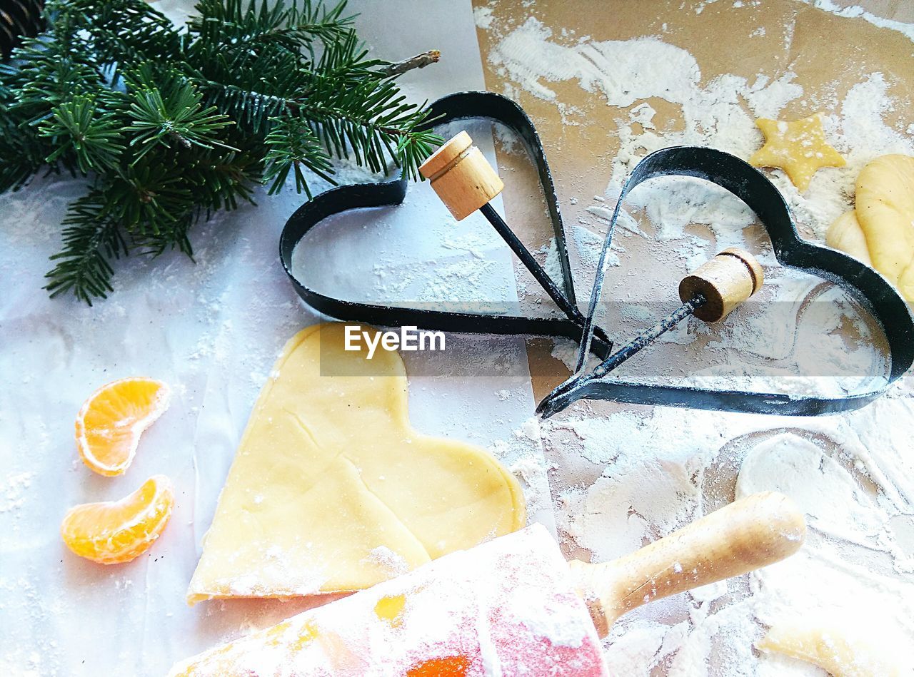 High angle view of heart shape pastry cutter and dough