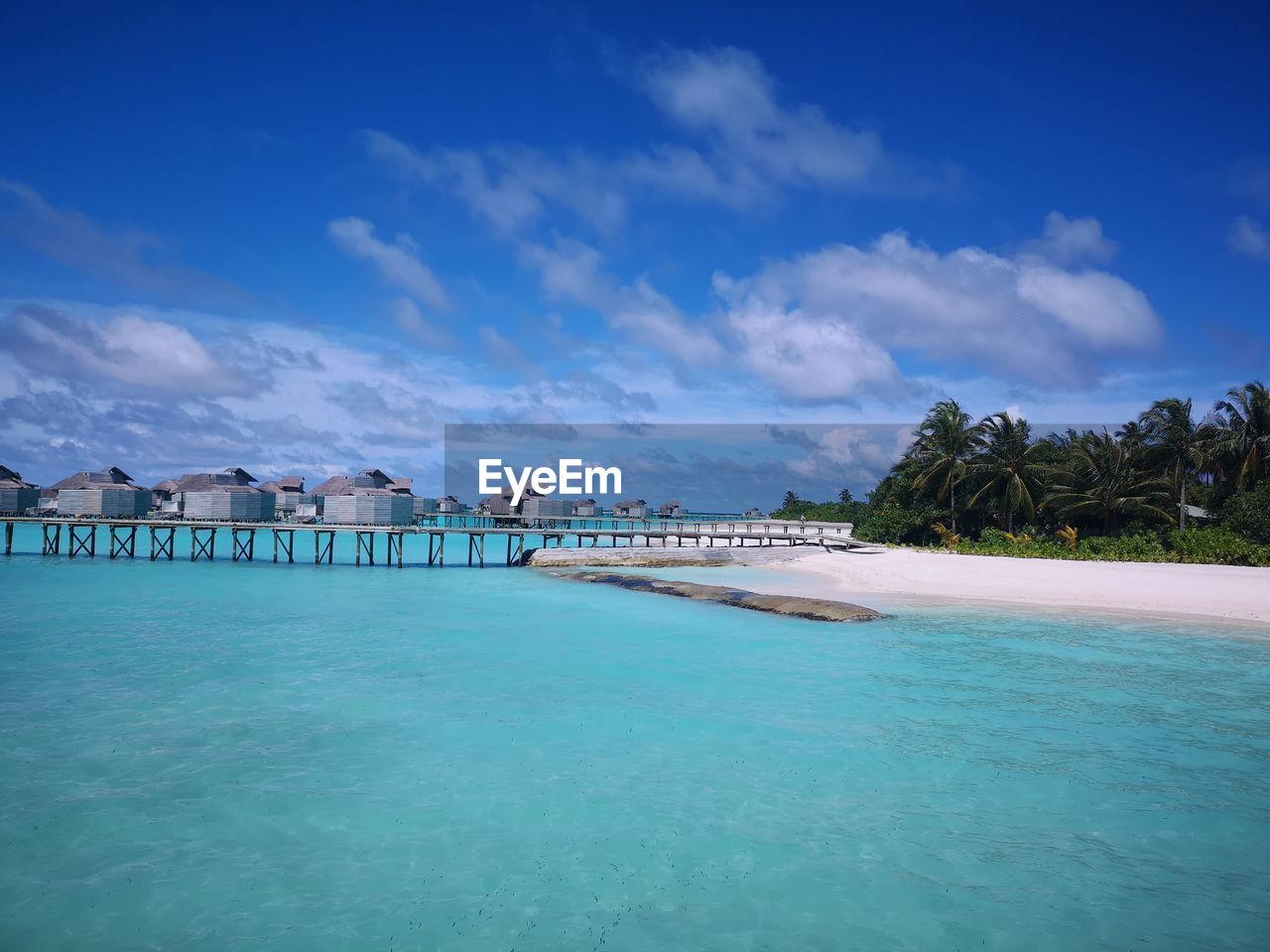 View of swimming pool by sea against sky