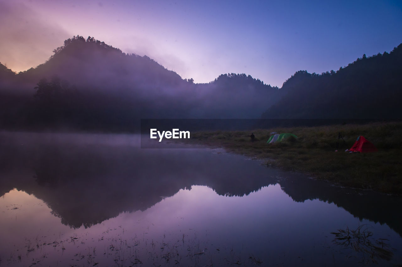 Scenic view of lake against sky during sunset