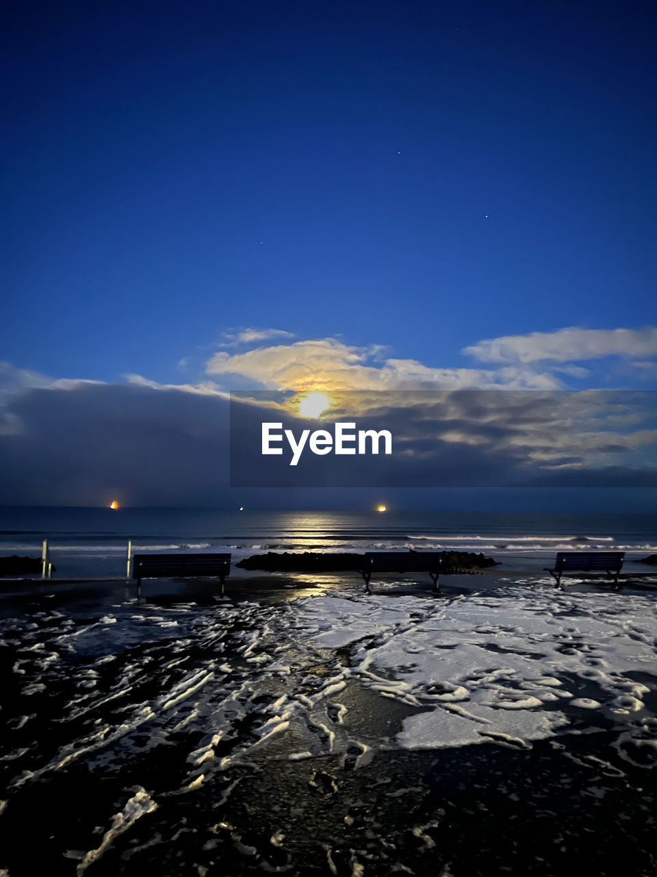 sky, horizon, water, sea, reflection, ocean, sunlight, nature, scenics - nature, dusk, beauty in nature, cloud, evening, land, beach, wave, environment, blue, sunset, tranquility, coast, no people, tranquil scene, outdoors, light, travel destinations, horizon over water, landscape, moonlight, shore, travel, astronomical object, seascape, idyllic