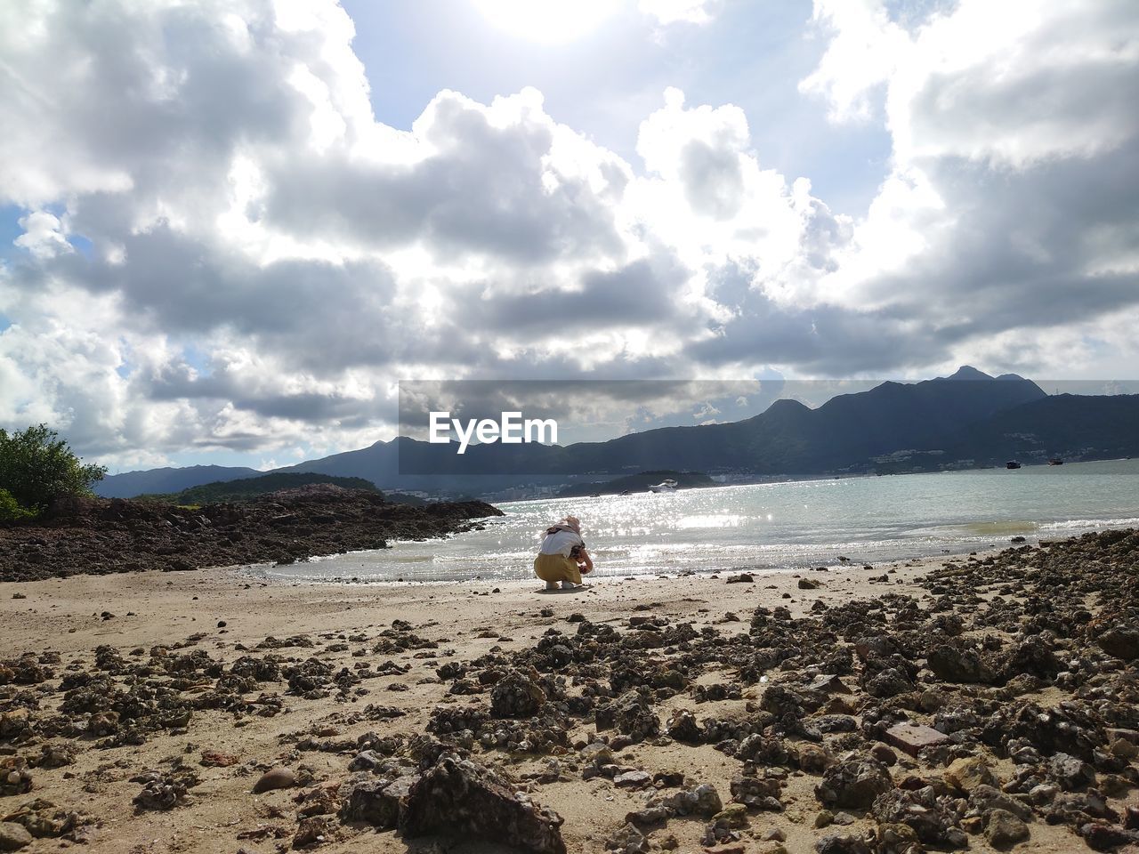 REAR VIEW OF PEOPLE ON BEACH