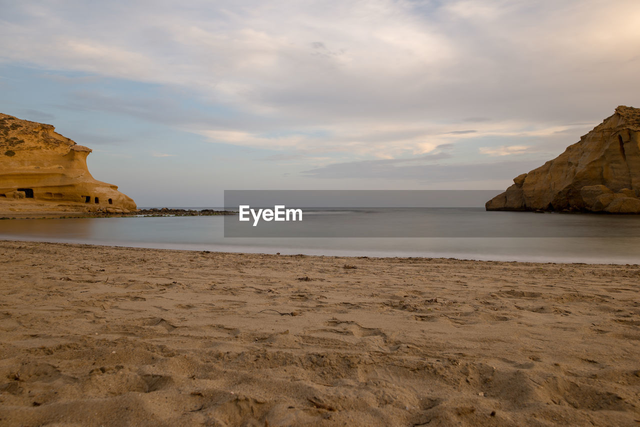 Scenic view of beach against sky during sunset