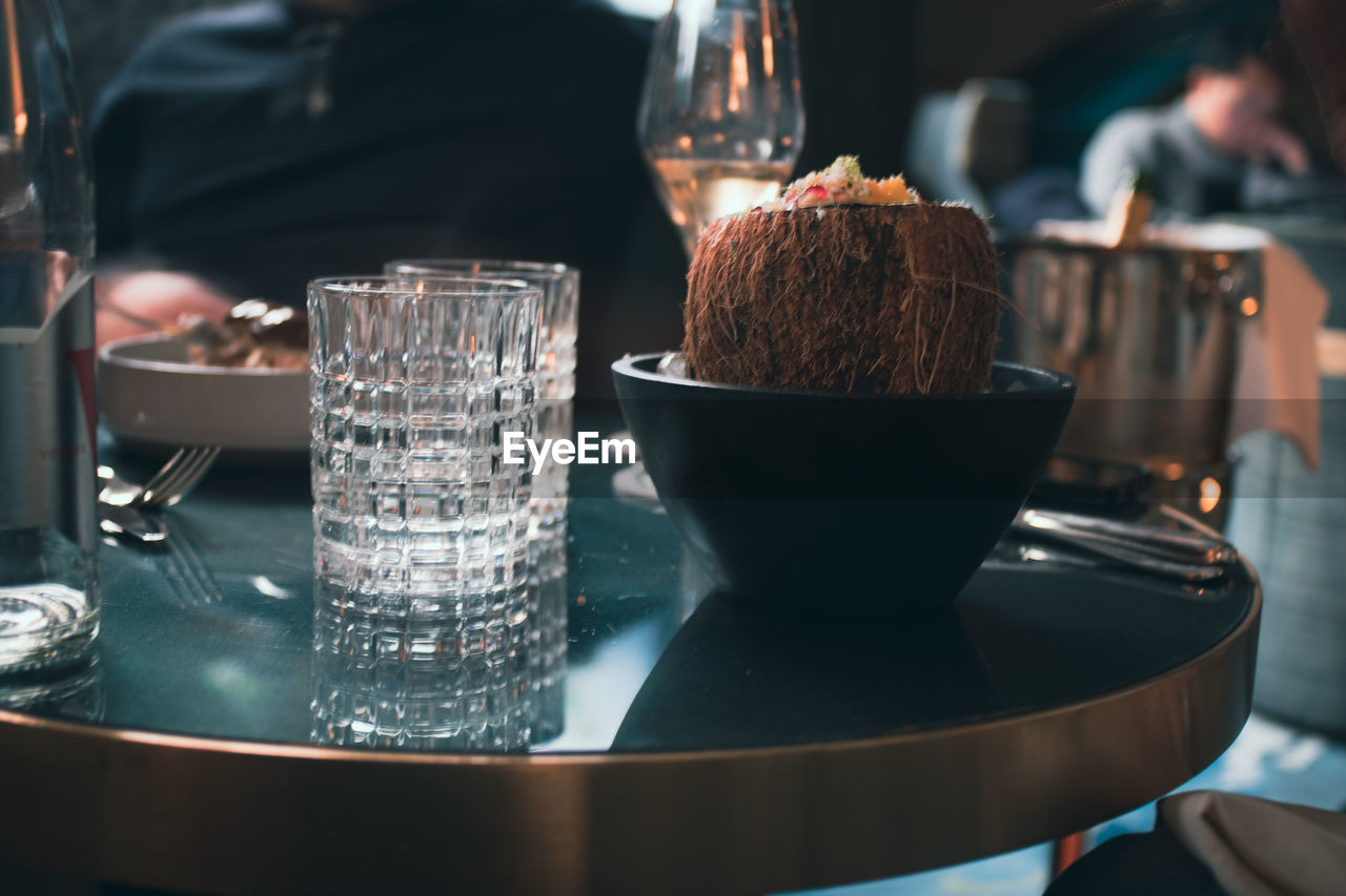 Close-up of food and glasses on table.