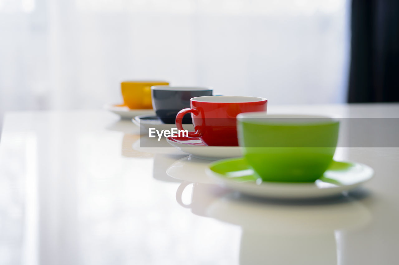 Close-up of colorful coffee cups on table