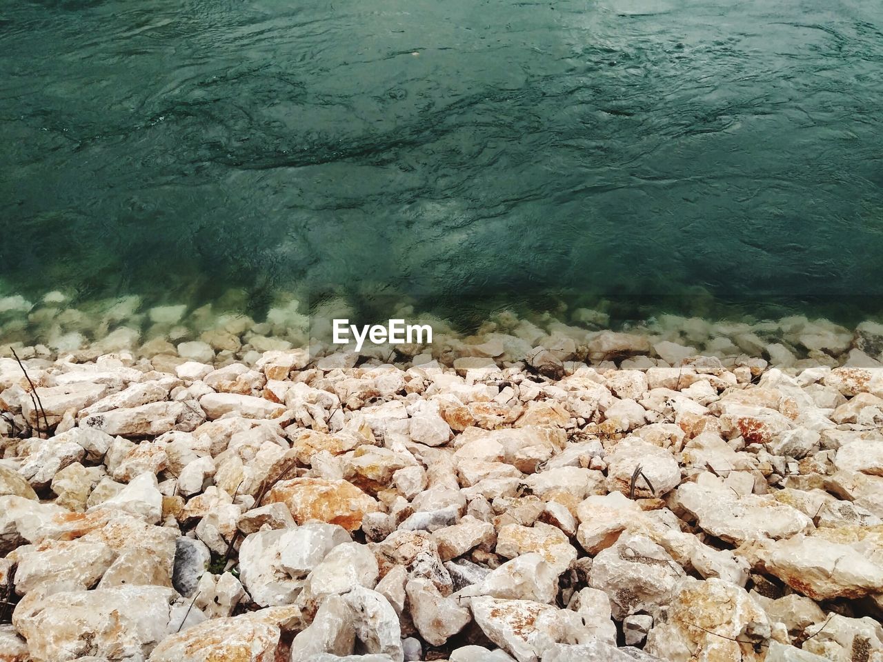 CLOSE-UP OF WATER FLOWING FROM LAKE