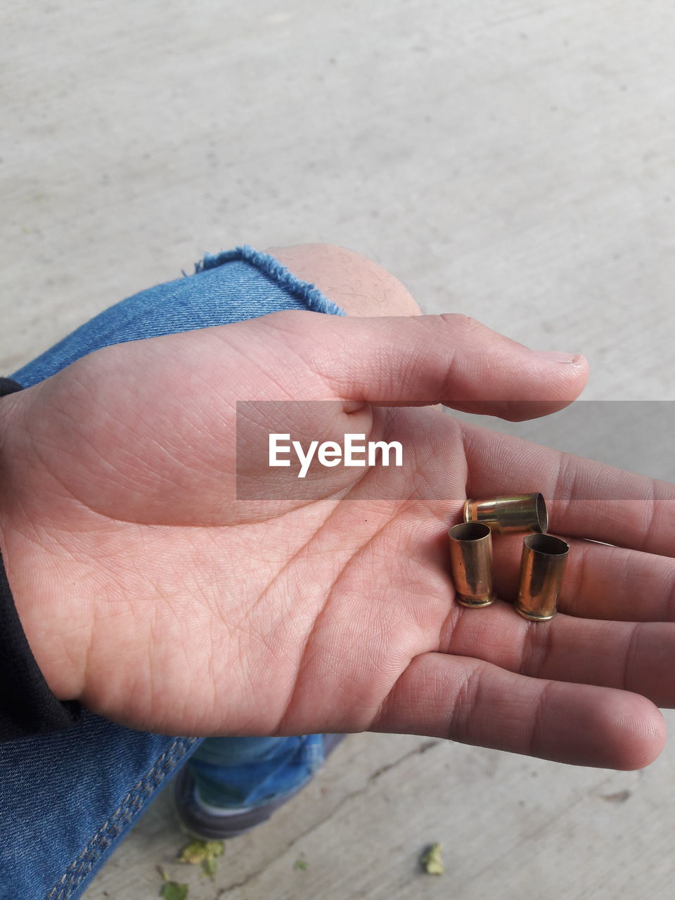 Close-up of hand holding bullet shells