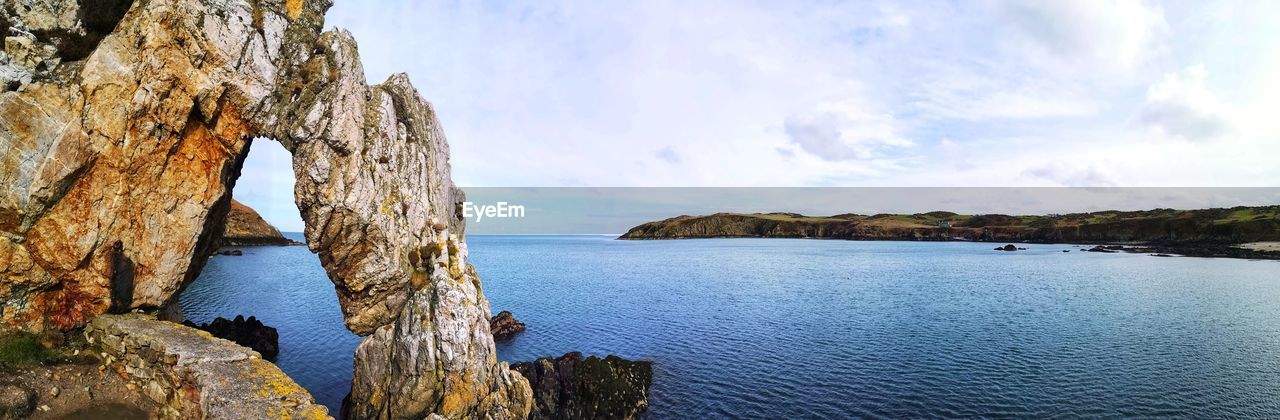 water, sky, sea, scenics - nature, beauty in nature, rock, nature, land, cloud, tranquility, panoramic, coast, cliff, beach, tranquil scene, travel destinations, no people, travel, day, landscape, coastline, body of water, environment, shore, outdoors, idyllic, rock formation, non-urban scene, terrain, bay, tourism, blue, mountain, plant, trip, tree, holiday, vacation, island, ocean