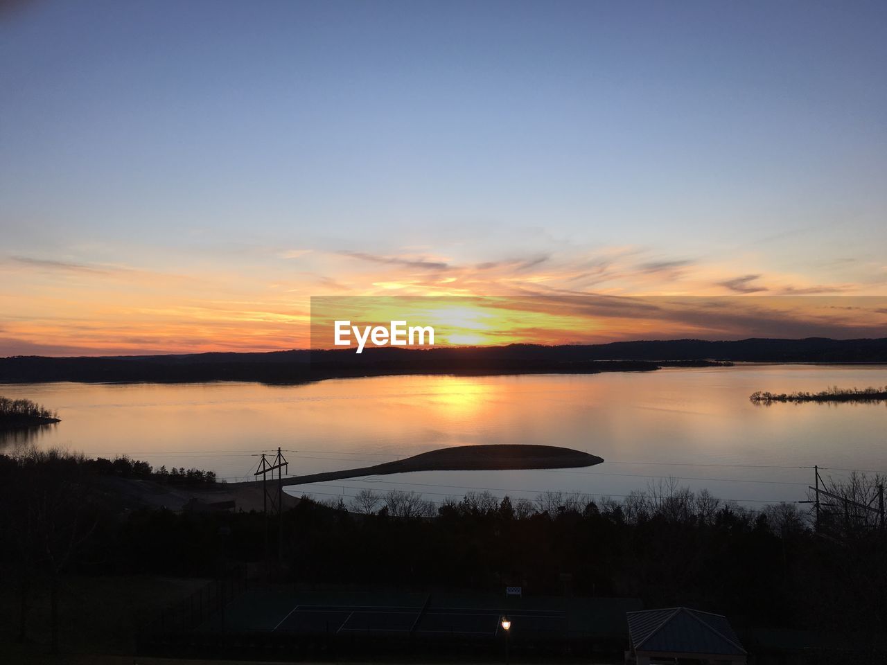 Scenic view of calm lake at sunset