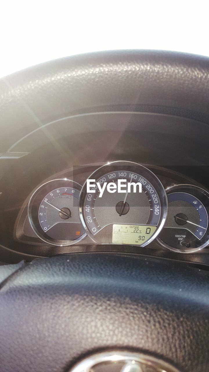 CLOSE-UP OF HUMAN EYE IN CAR SEEN THROUGH WINDSHIELD