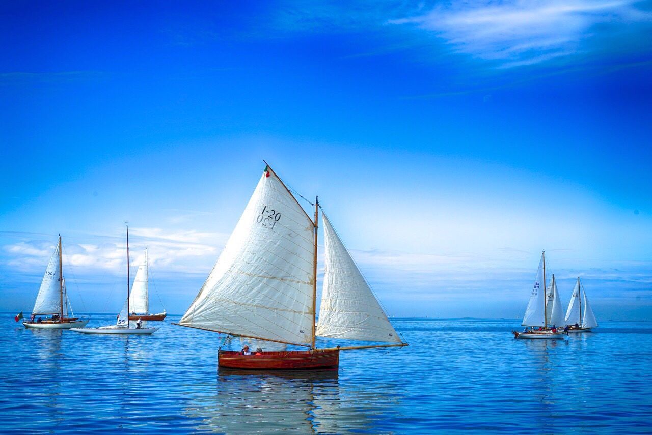 BOATS IN SEA WITH BOATS IN BACKGROUND