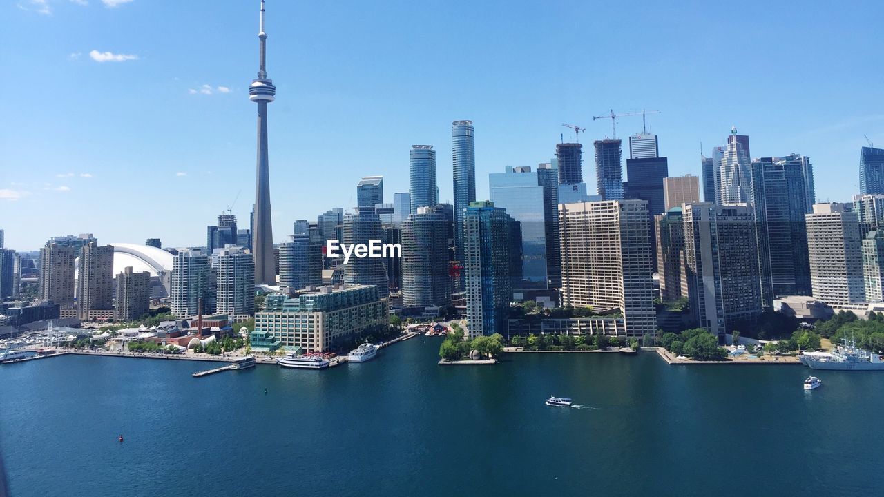 Cityscape by lake ontario against sky