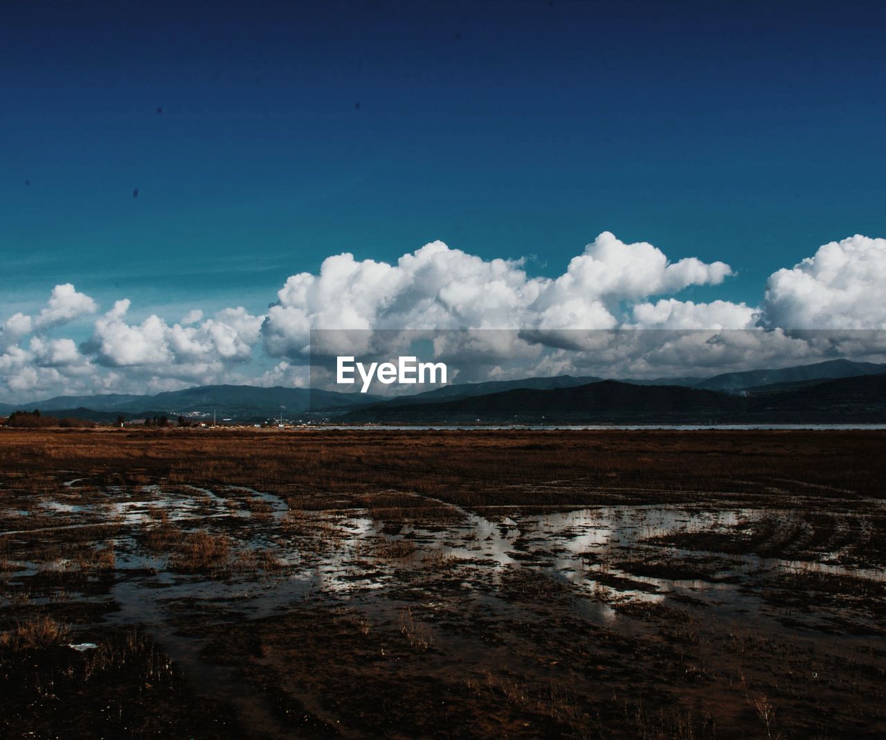 Scenic view of mountains against cloudy sky