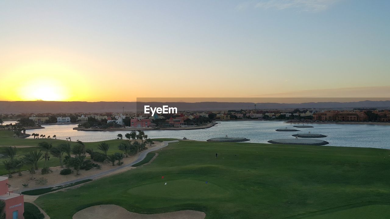 High angle view of sea and city against clear sky