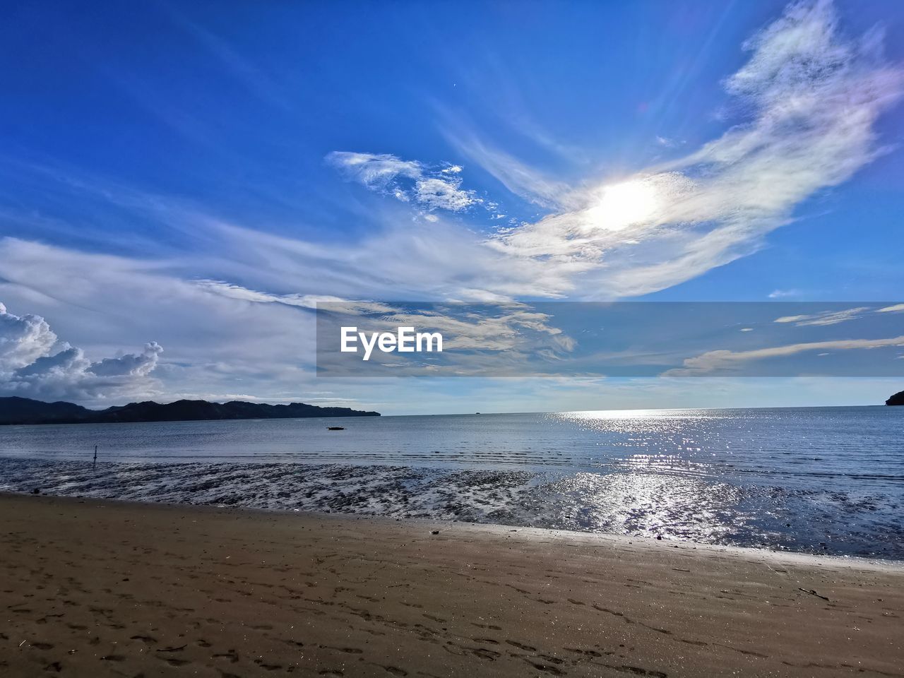 SCENIC VIEW OF BEACH AGAINST BLUE SKY