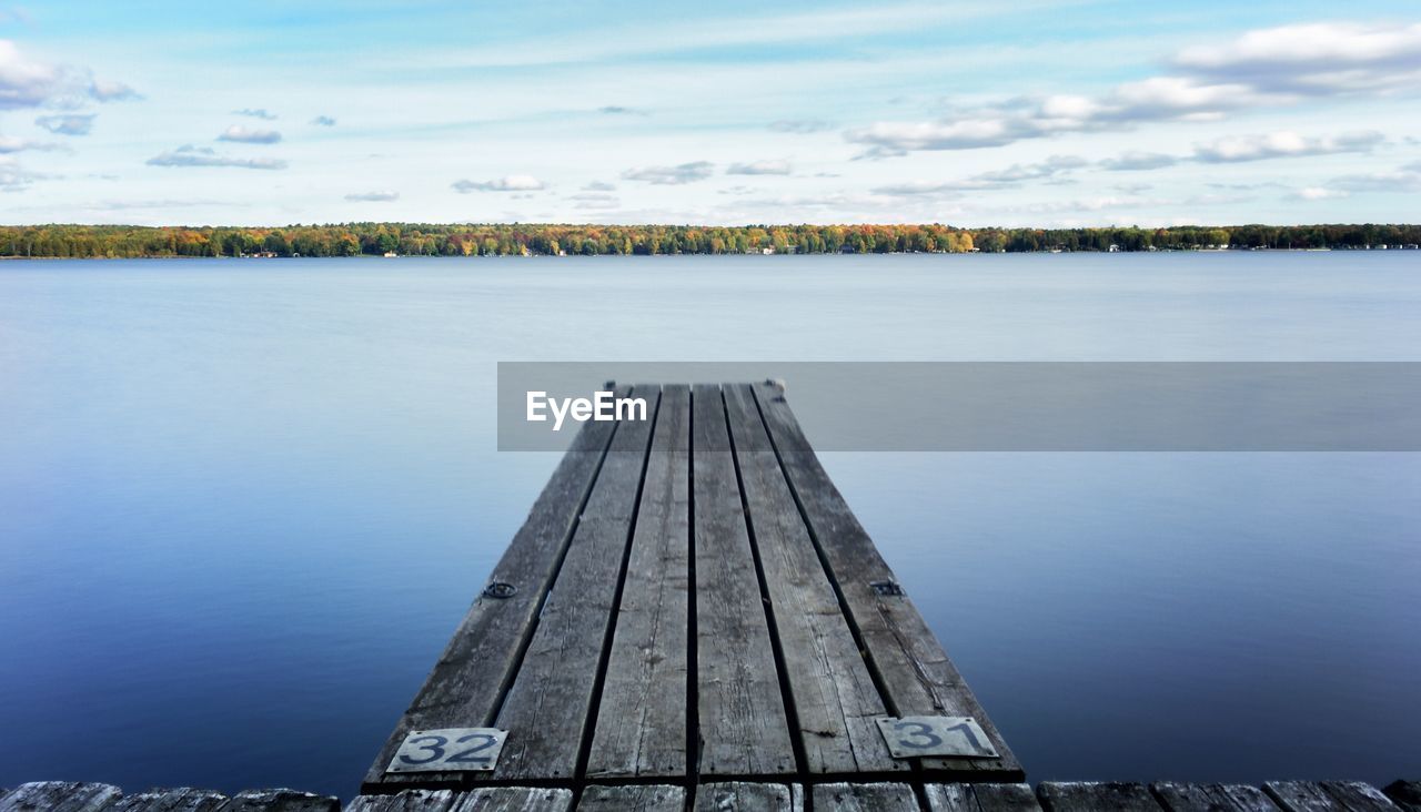 Pier over lake against sky