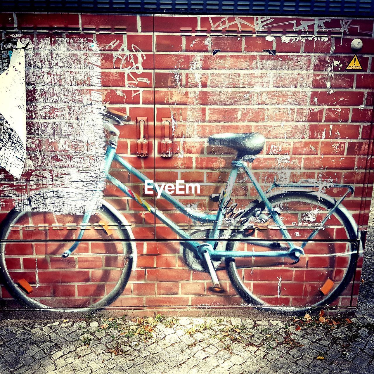 BICYCLE ON BRICK WALL