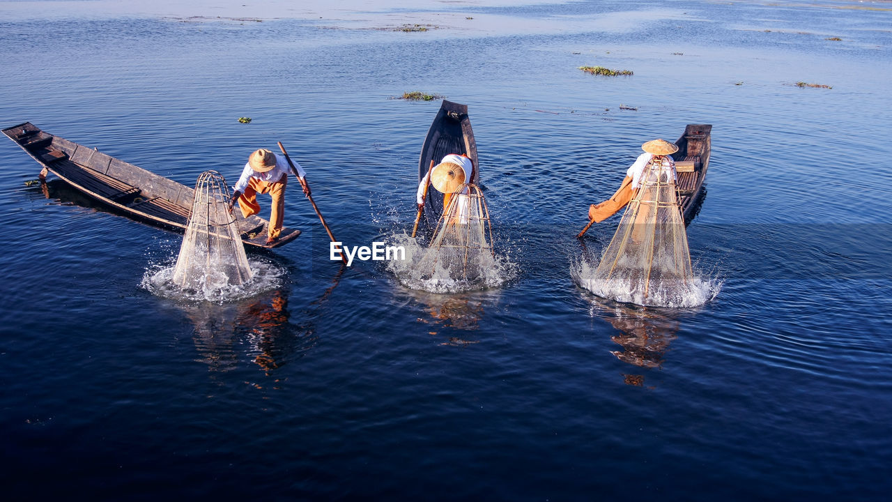 Intha fisherman on boat in river