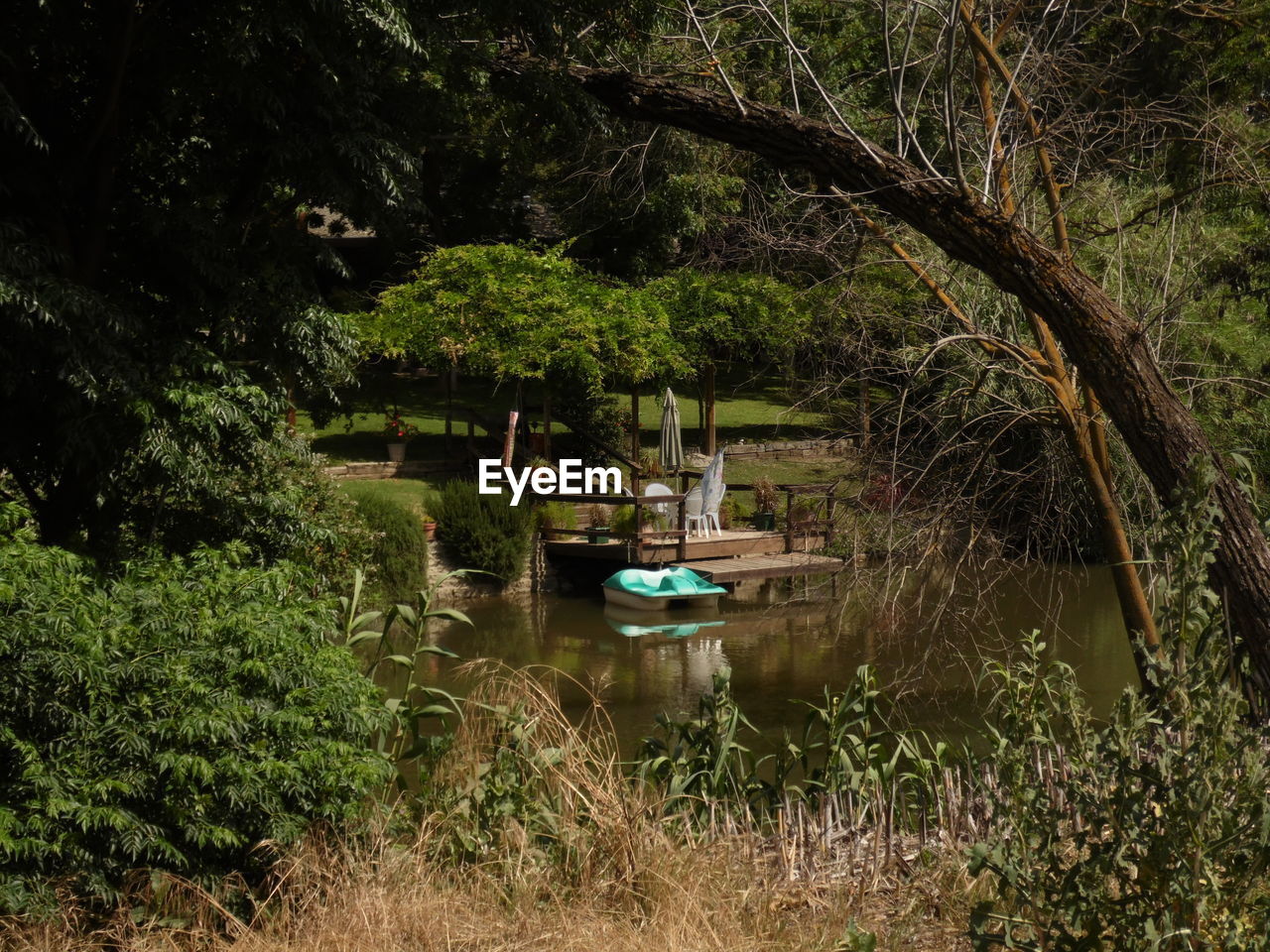 High angle view of pedal boat on lake amidst trees