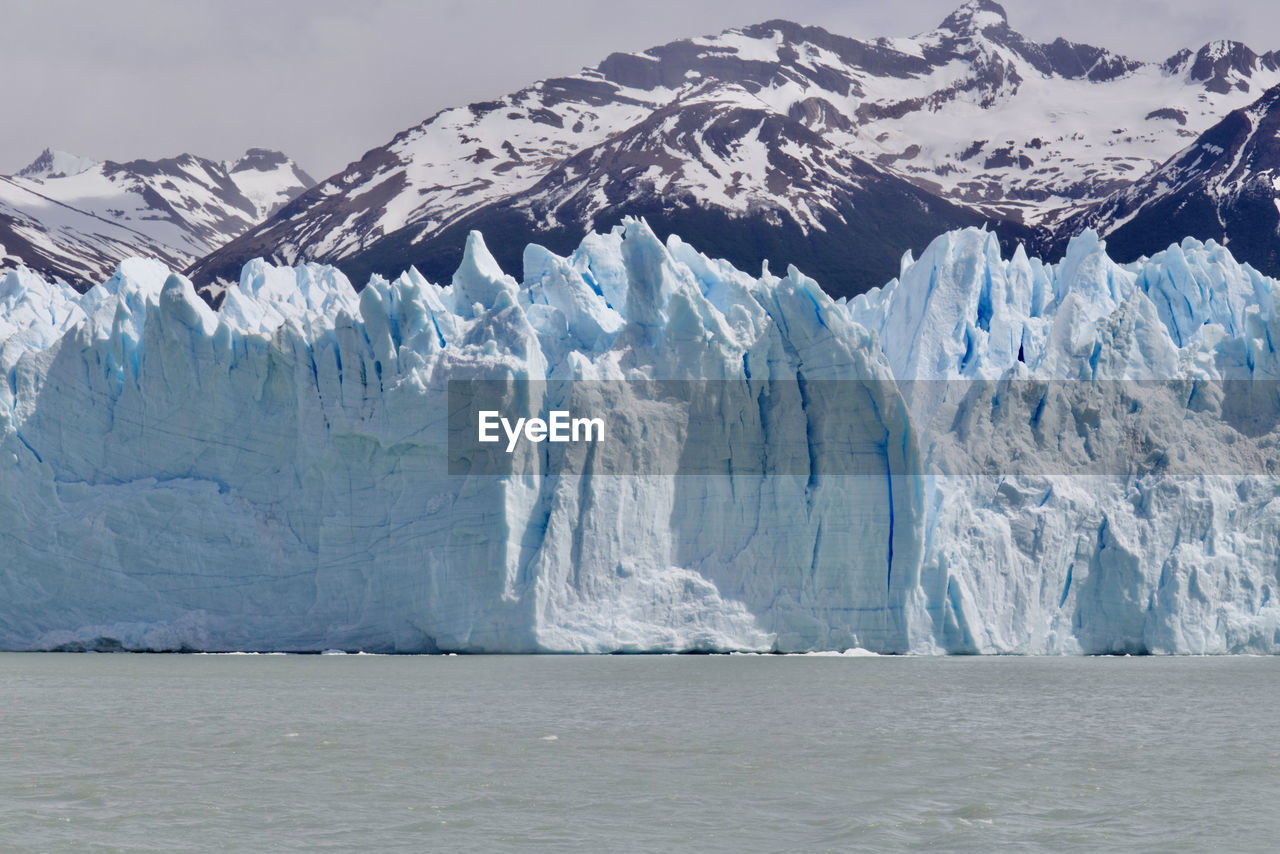 Scenic view of snowcapped mountains and glacier against sky