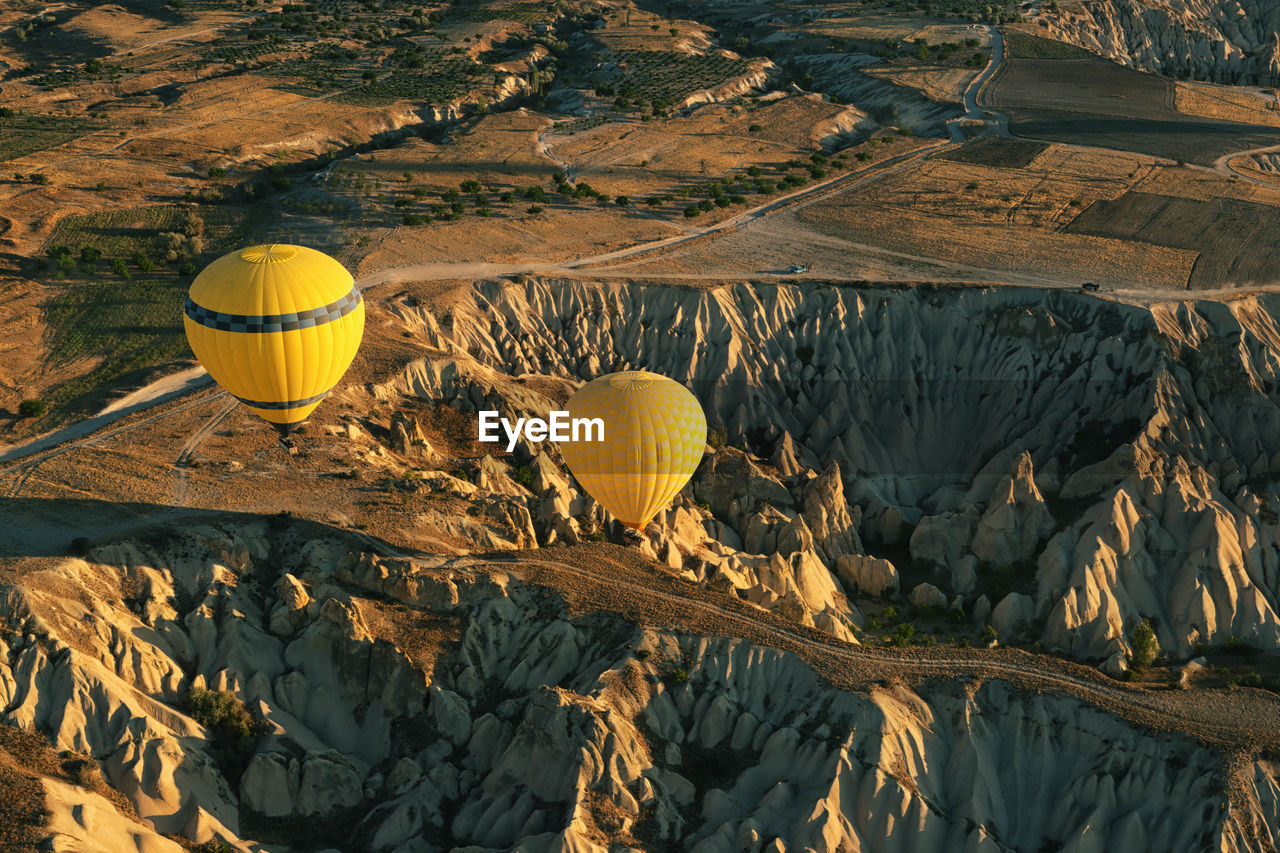 High angle view of hot air balloons over mountains at cappadocia