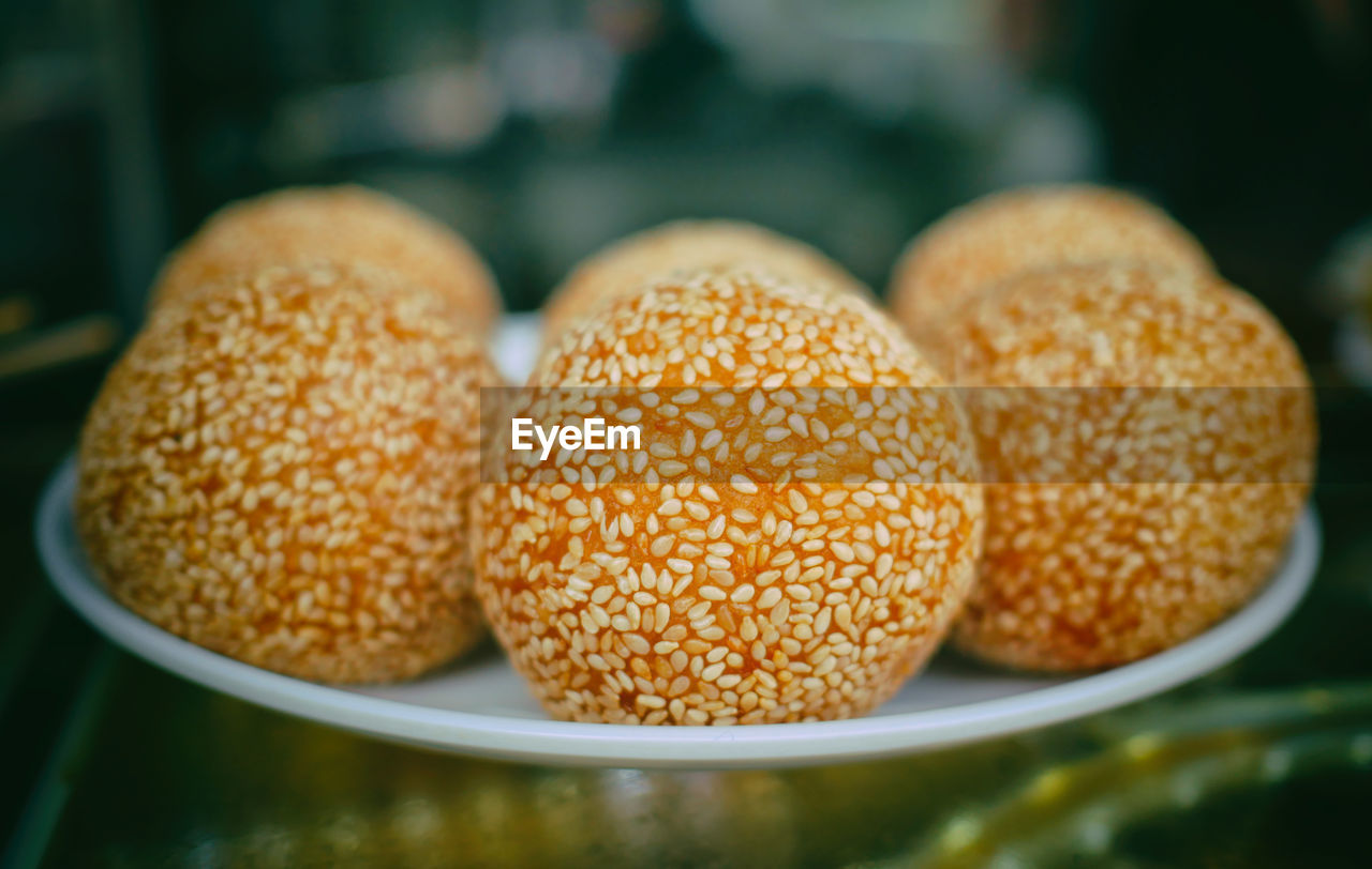 Close-up of 
sesame balls in plate on table