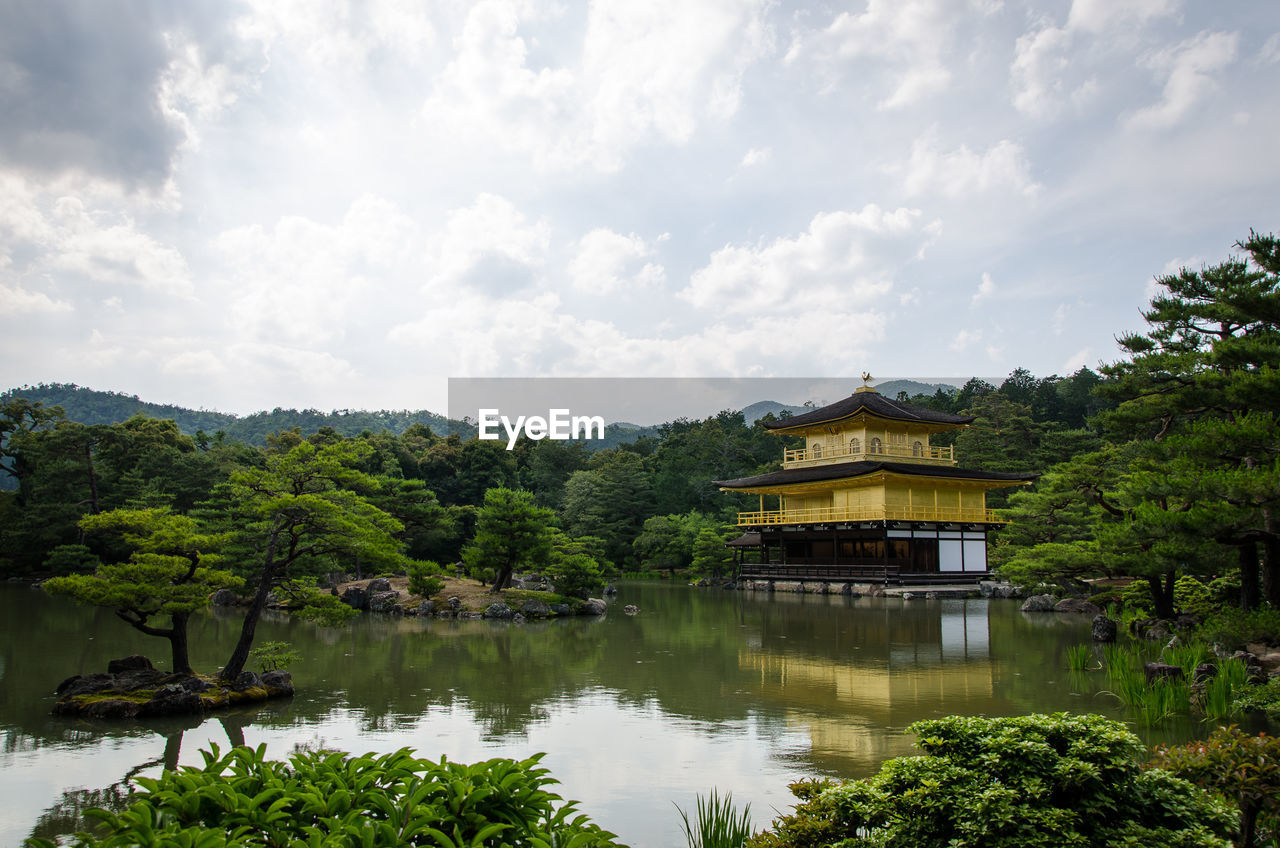 BUILT STRUCTURE BY LAKE AGAINST SKY