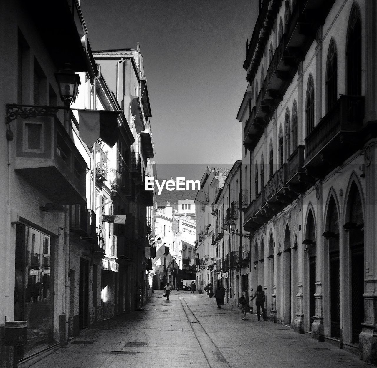 NARROW ALLEY WITH BUILDINGS IN BACKGROUND