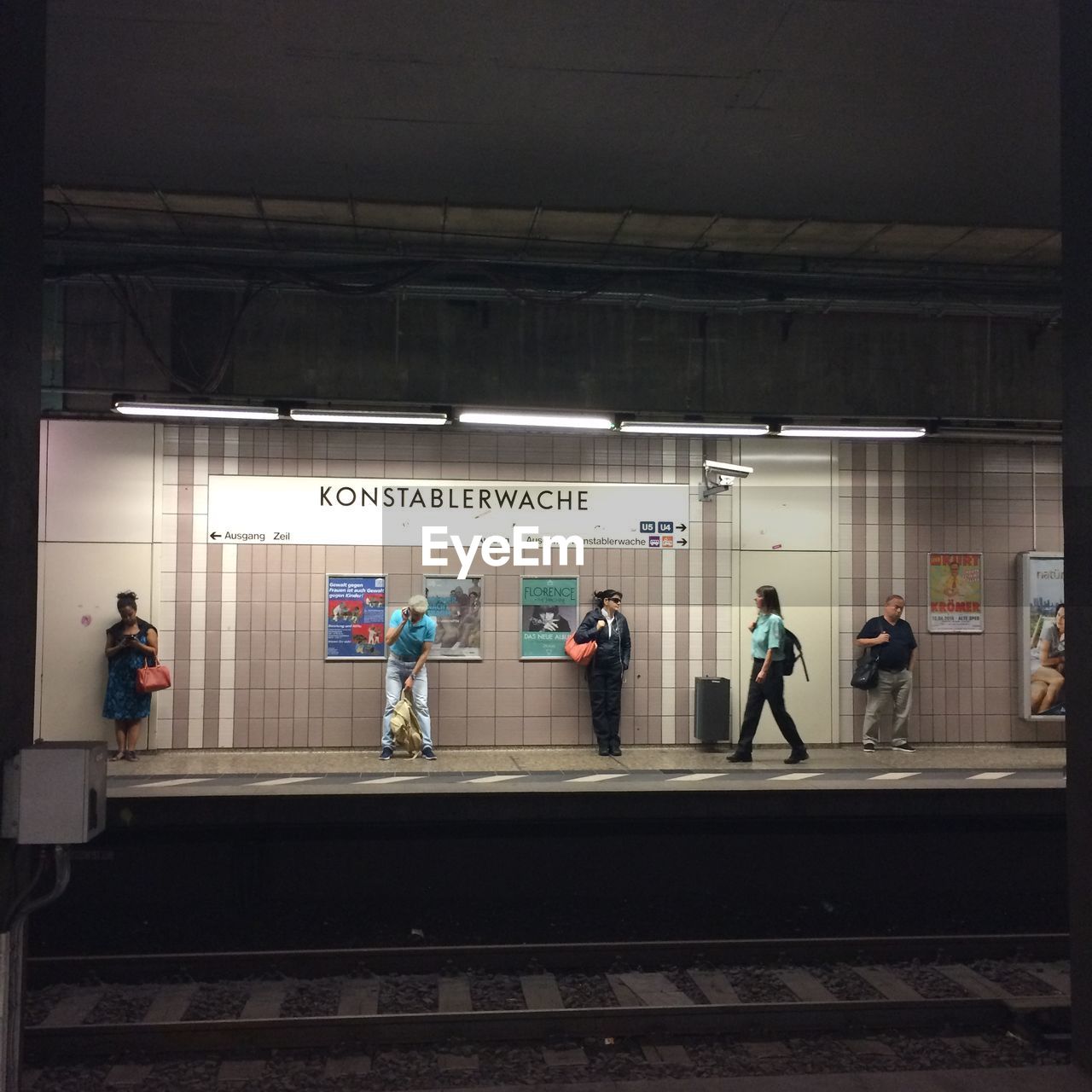 PEOPLE ON RAILROAD STATION PLATFORM