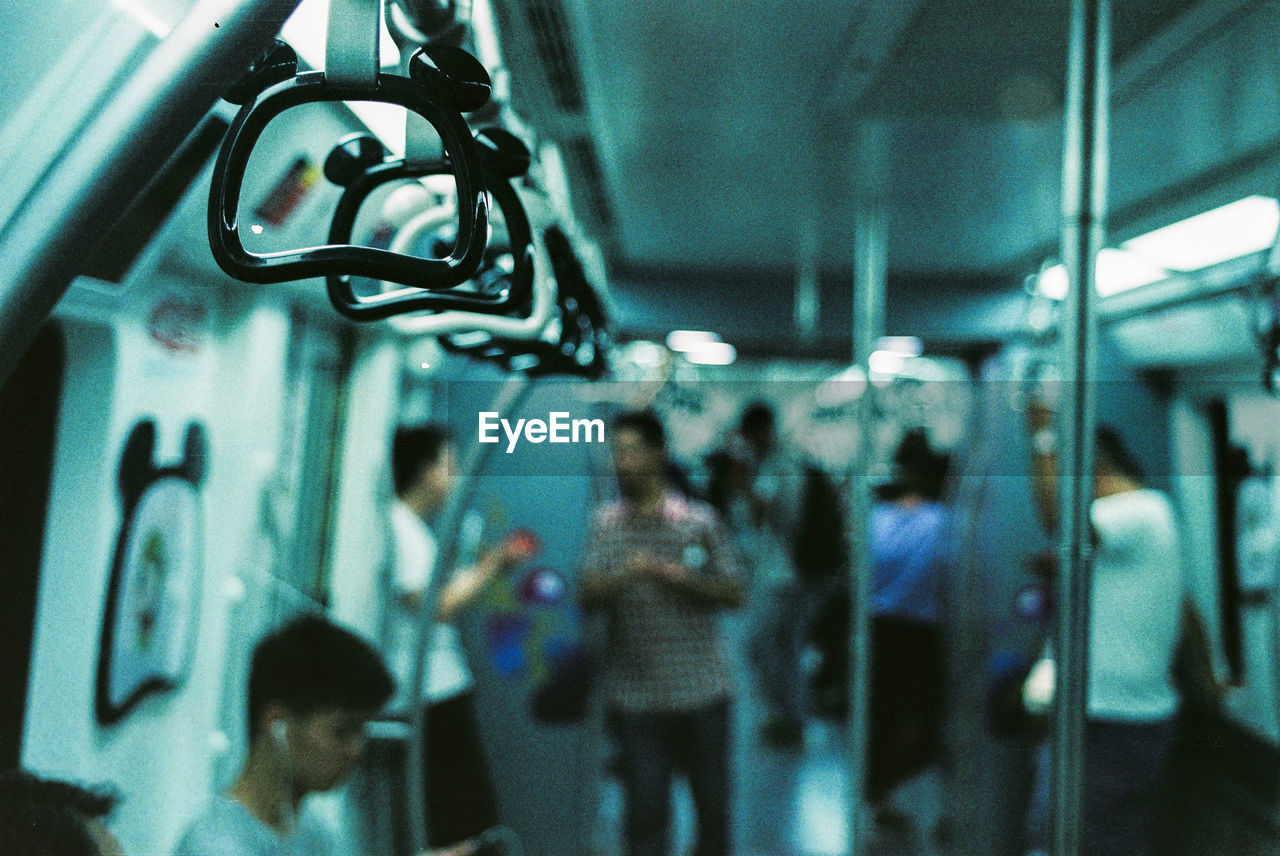 Side view of people traveling in train