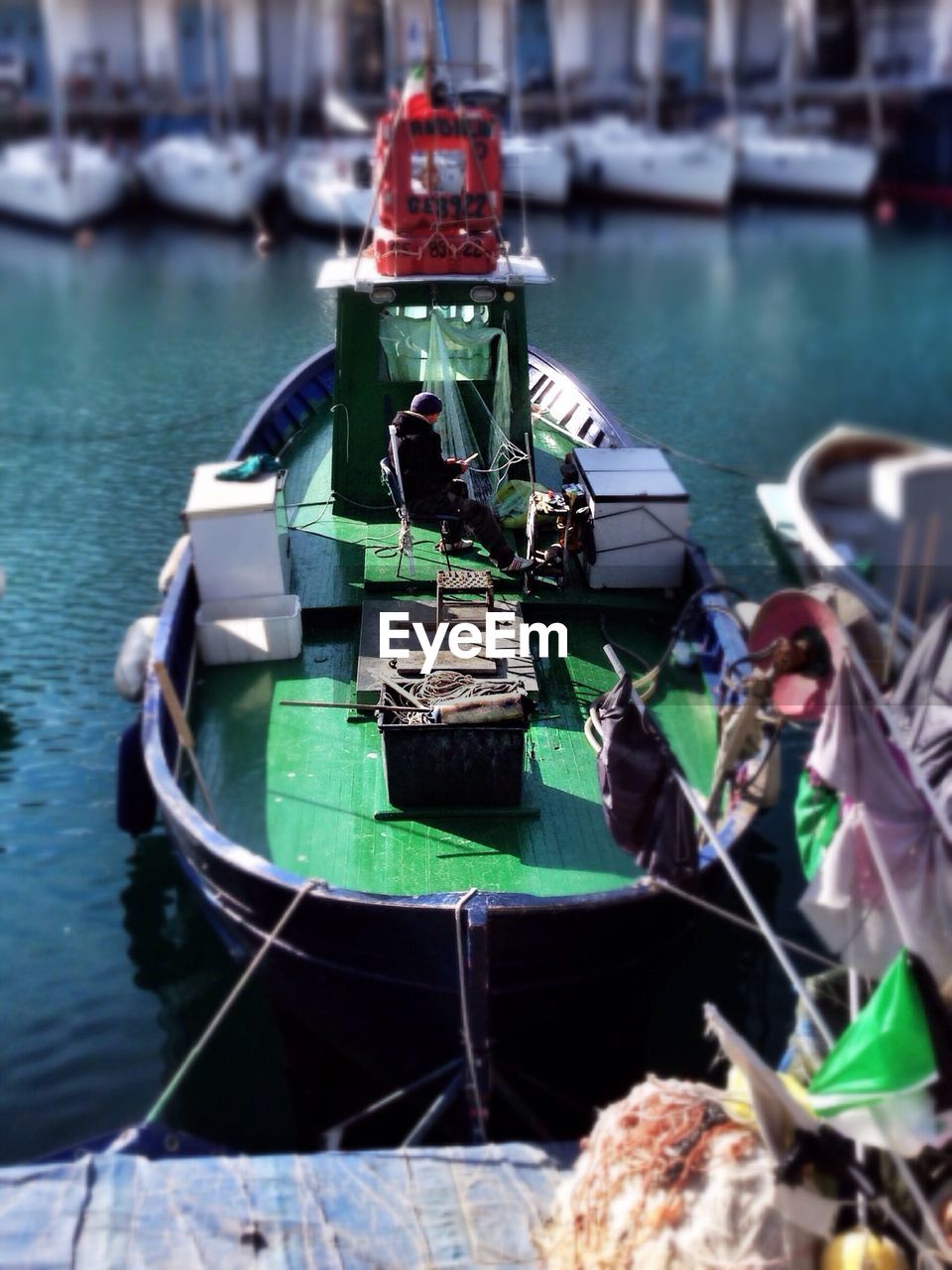 BOATS MOORED IN HARBOR