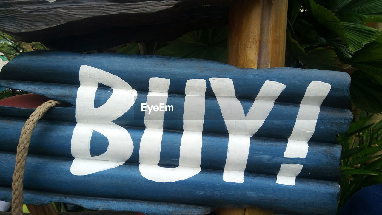 Buy sign on wooden structure