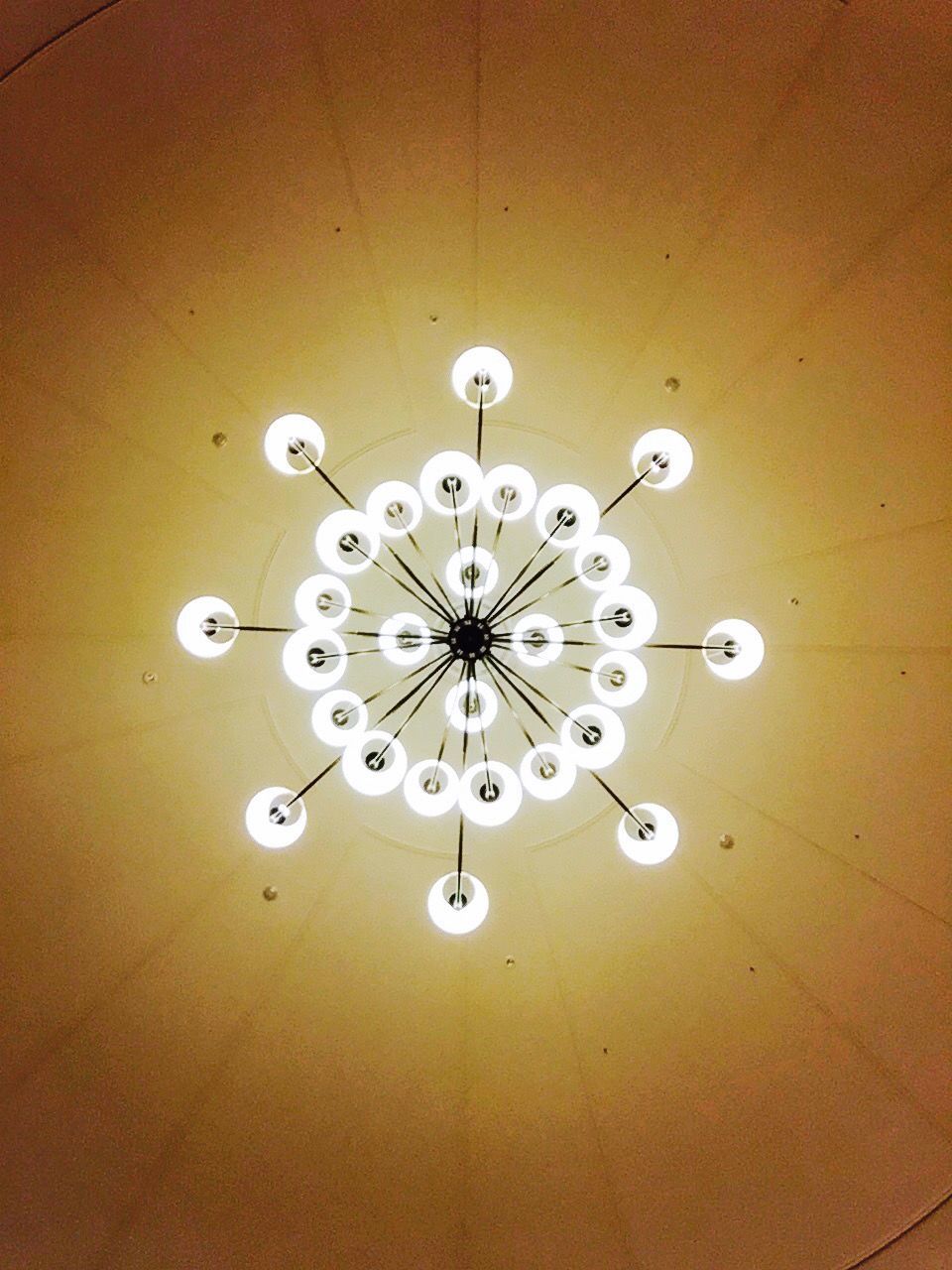 LOW ANGLE VIEW OF ILLUMINATED CHANDELIER